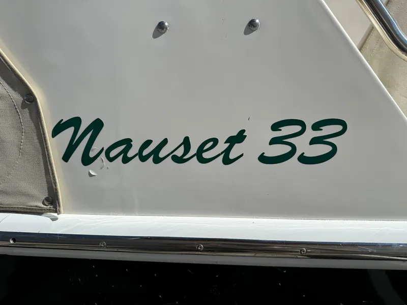 Slide: The Image of Nauset 33 boat, 2004 model, white hull with green lettering. - 6