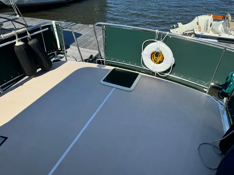 Slide: The Image of 2004 Nauset 33 boat deck with safety equipment and dock view. - 8