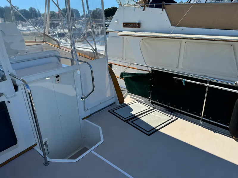 Slide: The Image of 2004 Nauset 33 boat deck with seating and railing, docked at marina. - 9