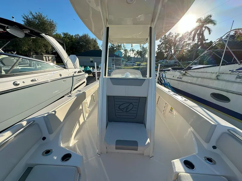 Slide: The Image of 2025 Sailfish 232 boat with T-top and rod holders under clear blue sky. - 14