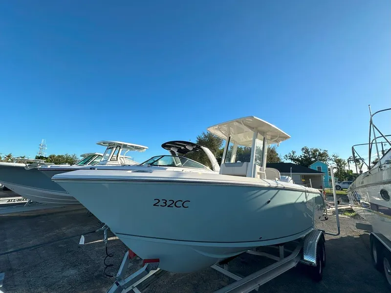 Slide: The Image of 2025 Sailfish 232 boat in a marina, surrounded by other vessels. - 2