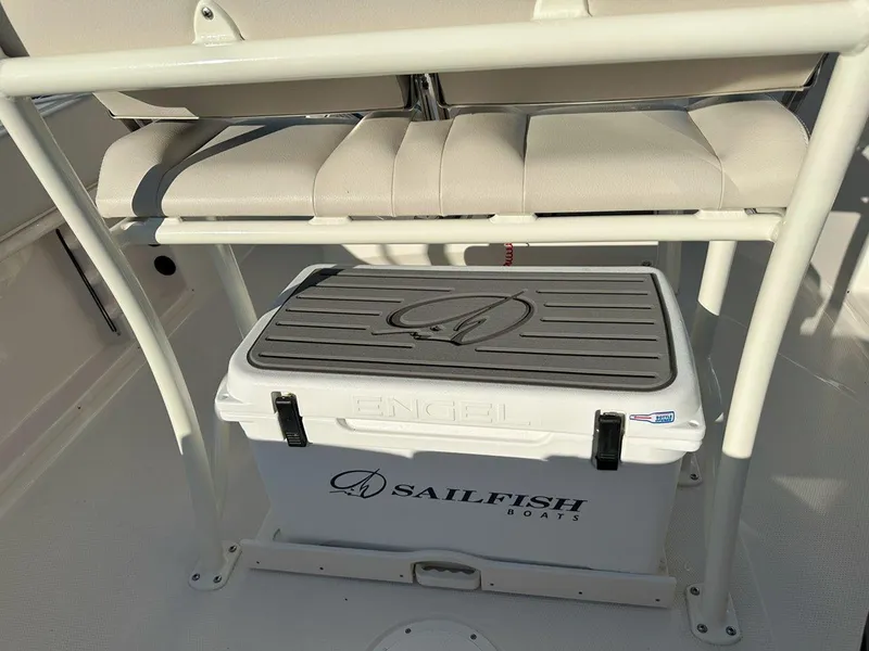 Slide: The Image of 2025 Sailfish 232 boat interior with seating, surrounded by other boats in a marina. - 23