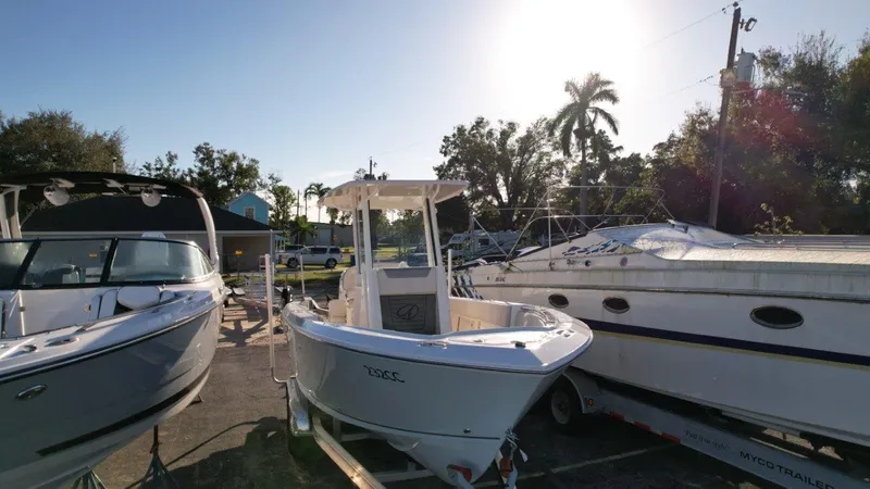 Slide: The Image of 2025 Sailfish 232 boat on trailer under clear blue sky. - 5