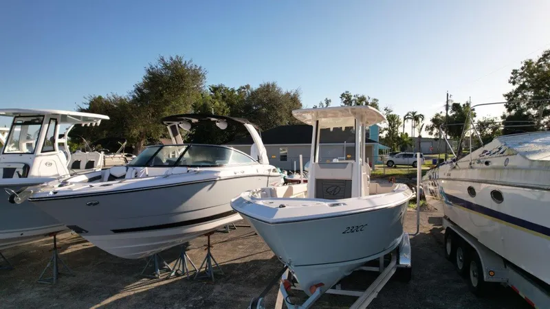 Slide: The Image of 2025 Sailfish 232 boat on trailer under clear blue sky. - 6
