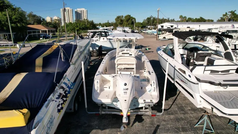 Slide: The Image of 2025 Sailfish 232 boat with Yamaha V6 engine, parked on a trailer under clear blue sky. - 8
