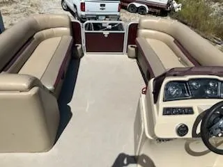 Slide: The Image of 2019 Sweetwater 2286SB pontoon boat interior with beige seating and steering console. - 8