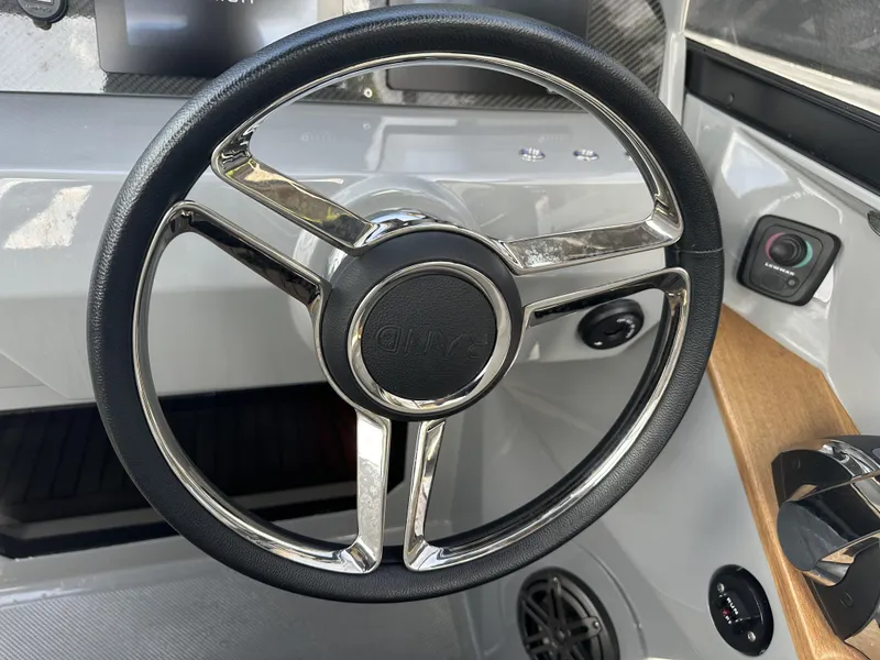 Slide: The Image of Steering wheel of a 2021 Rand Leisure boat, featuring sleek design and modern controls. - 16