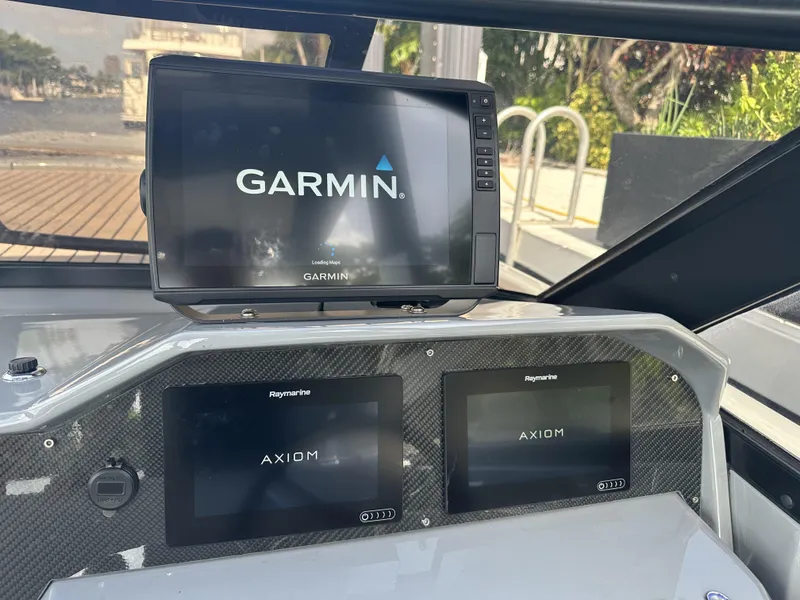 Slide: The Image of Dashboard of a 2021 Rand Leisure boat with Garmin and Raymarine Axiom displays. - 17