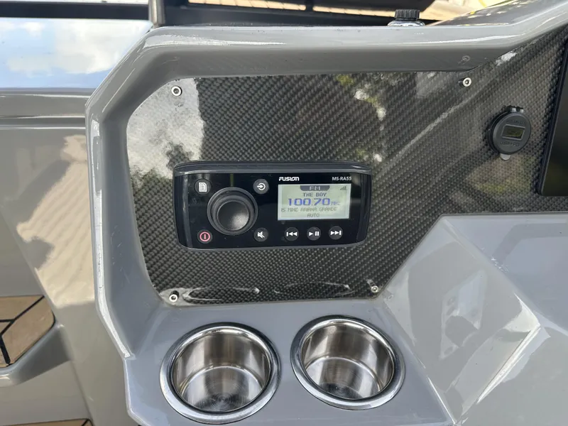 Slide: The Image of Control panel of 2021 Rand Leisure boat with stereo system and cup holders. - 18