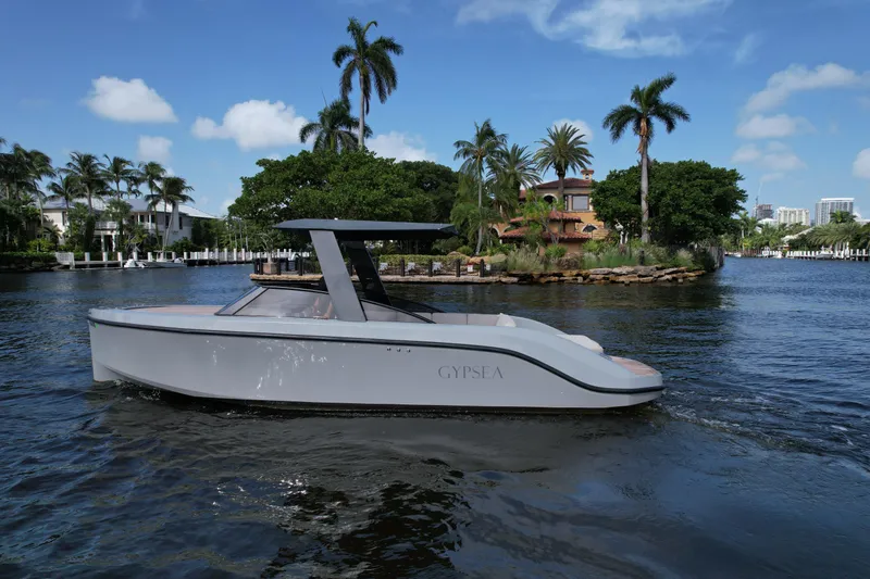Slide: The Image of Modern 2021 Rand Leisure boat cruising on a scenic, tropical waterway. - 2