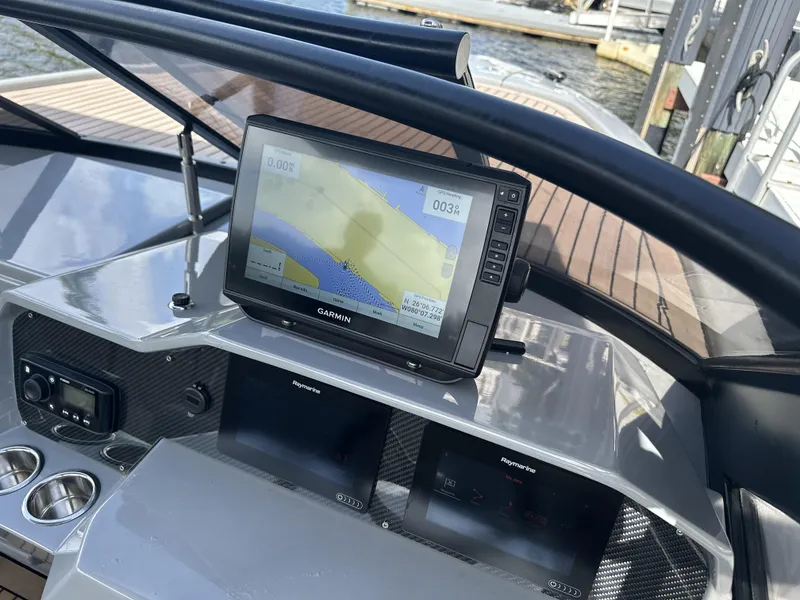 Slide: The Image of Dashboard of a 2021 Rand Leisure boat featuring a Garmin navigation system. - 21