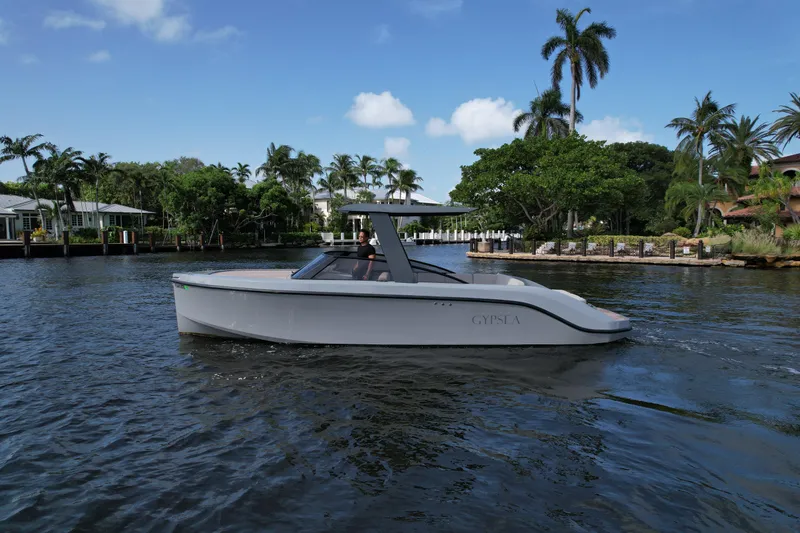 Slide: The Image of 2021 Rand Leisure boat cruising on a tropical waterway with palm trees in the background. - 23