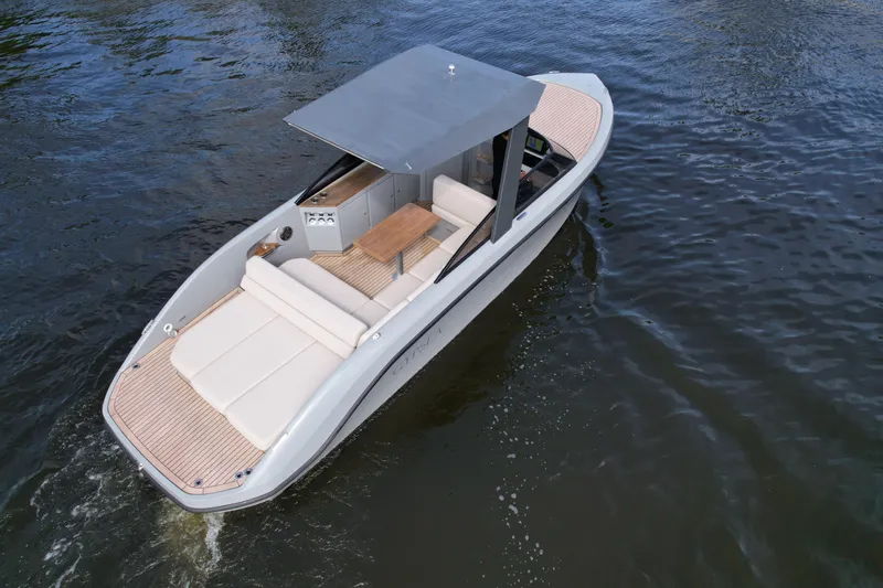 Slide: The Image of Modern 2021 Rand Leisure boat cruising on water, featuring sleek design and comfortable seating. - 25