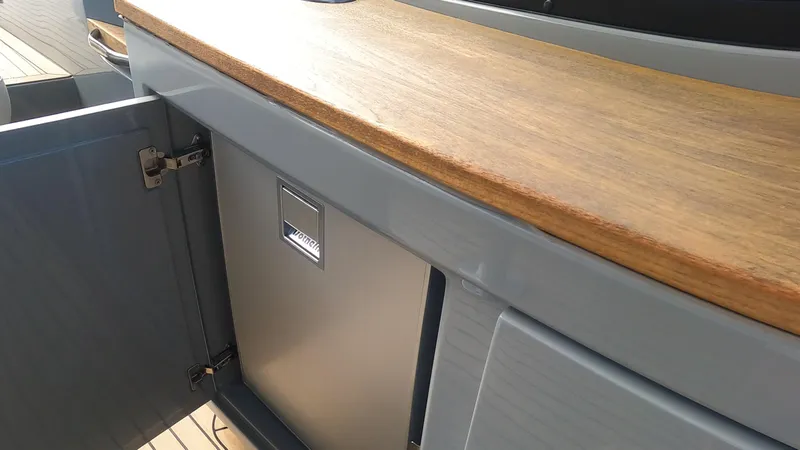 Slide: The Image of 2021 Rand Leisure boat interior with wooden countertop and open storage compartment. - 36