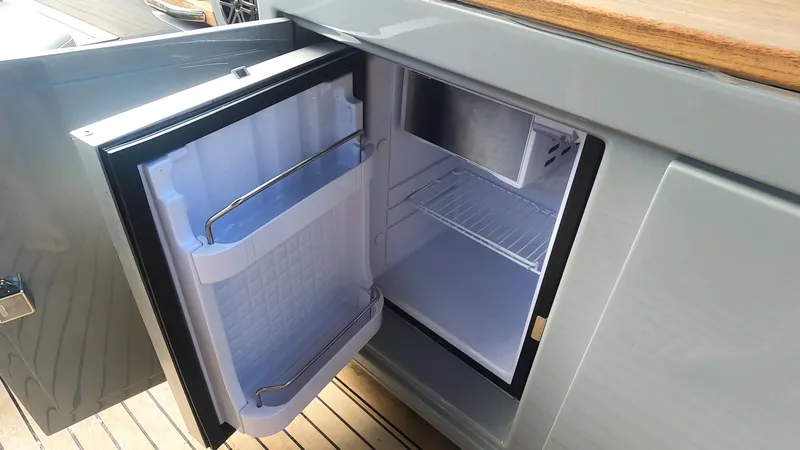 Slide: The Image of Open mini fridge on Rand Leisure 2021 boat, showcasing interior storage space. - 39