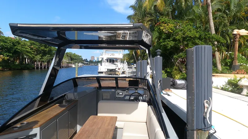 Slide: The Image of 2021 Rand Leisure boat docked by a scenic waterfront with lush greenery. - 46