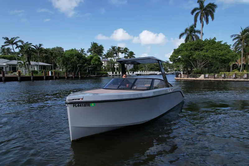 Slide: The Image of Modern 2021 Rand Leisure boat cruising on a scenic waterway with palm trees. - 5