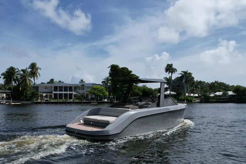 Slide: The Image of 2021 Rand Leisure boat cruising on a scenic waterway with palm trees and houses. - 7