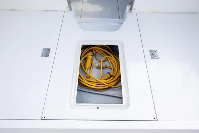 Slide: The Image of Yellow rope in storage compartment of 1983 Bertram 28 Moppie boat. - 10