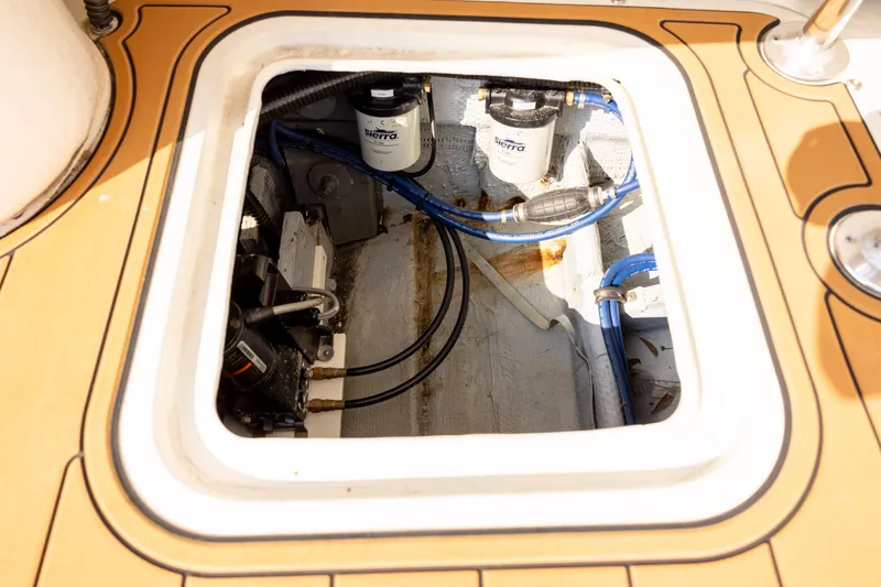 Slide: The Image of Engine compartment of 1983 Bertram 28 Moppie with visible filters and wiring. - 14
