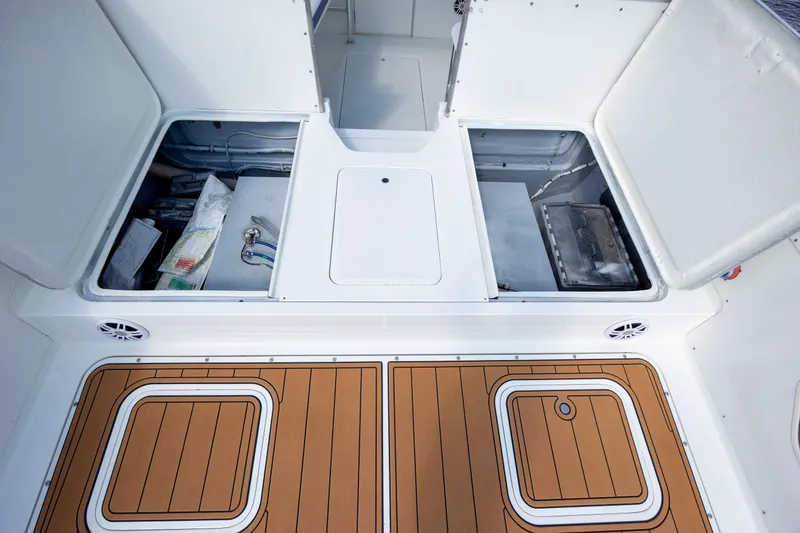 Slide: The Image of 1983 Bertram 28 Moppie boat storage compartments with teak flooring. - 15