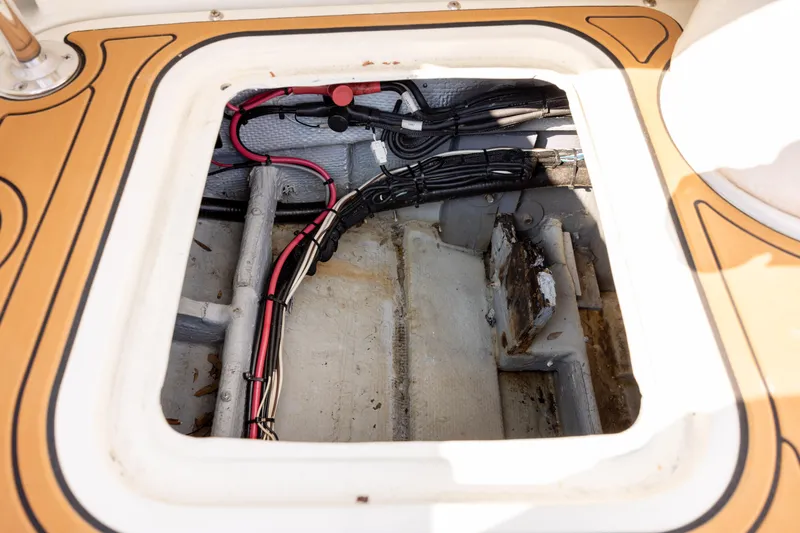 Slide: The Image of Open hatch of 1983 Bertram 28 Moppie showing wiring and interior structure. - 19