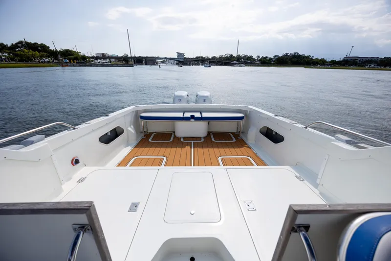 Slide: The Image of 1983 Bertram 28 Moppie boat with spacious deck and scenic water view. - 7