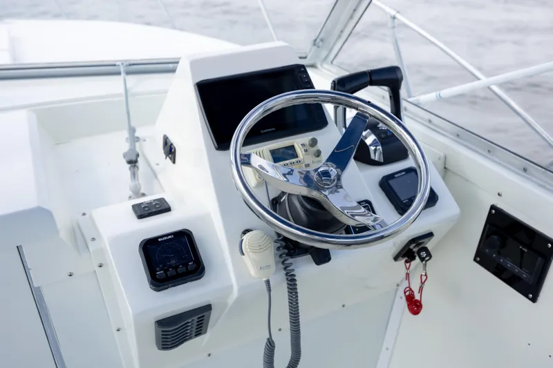 Slide: The Image of Cockpit of 1983 Bertram 28 Moppie boat with steering wheel and controls. - 9