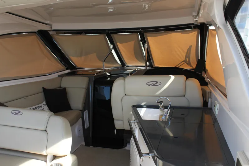 Slide: The Image of Interior of 2012 Regal 35 Sport Coupe with beige seating and modern design. - 18