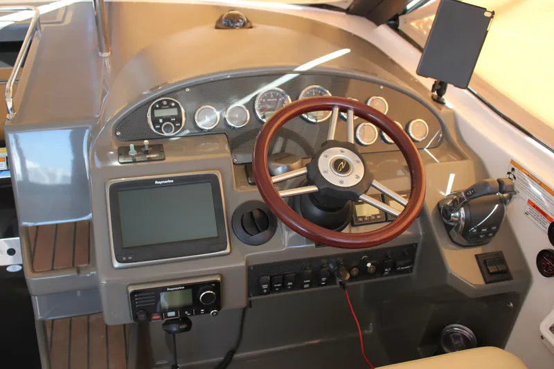 Slide: The Image of 2012 Regal 35 Sport Coupe dashboard with steering wheel and navigation controls. - 22