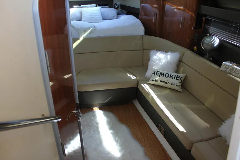 Slide: The Image of Interior of 2012 Regal 35 Sport Coupe with cozy seating and decorative pillows. - 25