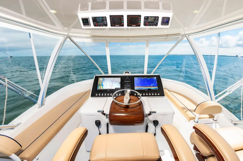 Slide: The Image of 2023 Viking 46 yacht helm with advanced navigation system and ocean view. - 11