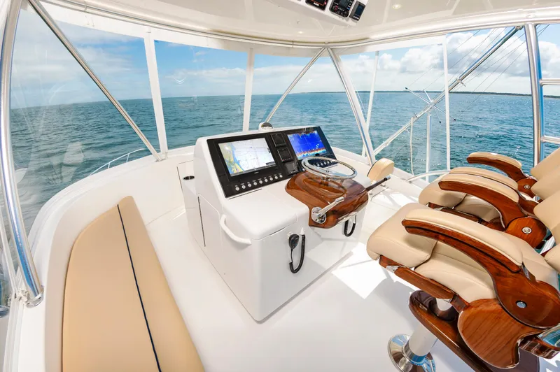 Slide: The Image of Luxurious 2023 Viking 46 yacht helm with ocean view and advanced navigation system. - 12