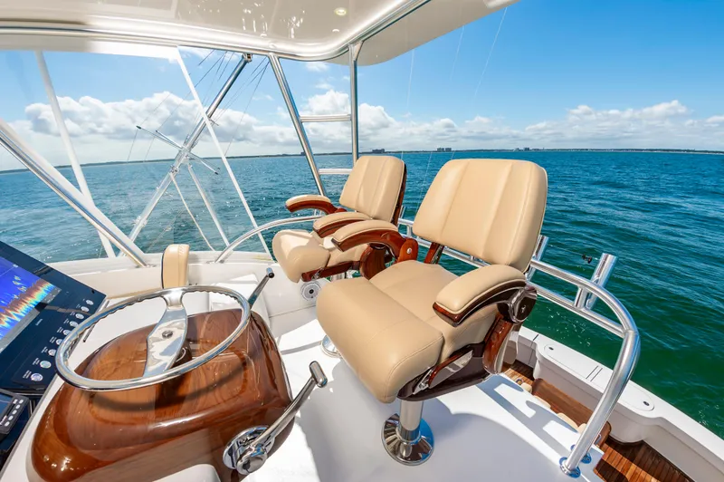 Slide: The Image of Luxurious 2023 Viking 46 yacht helm with leather seats and ocean view. - 13