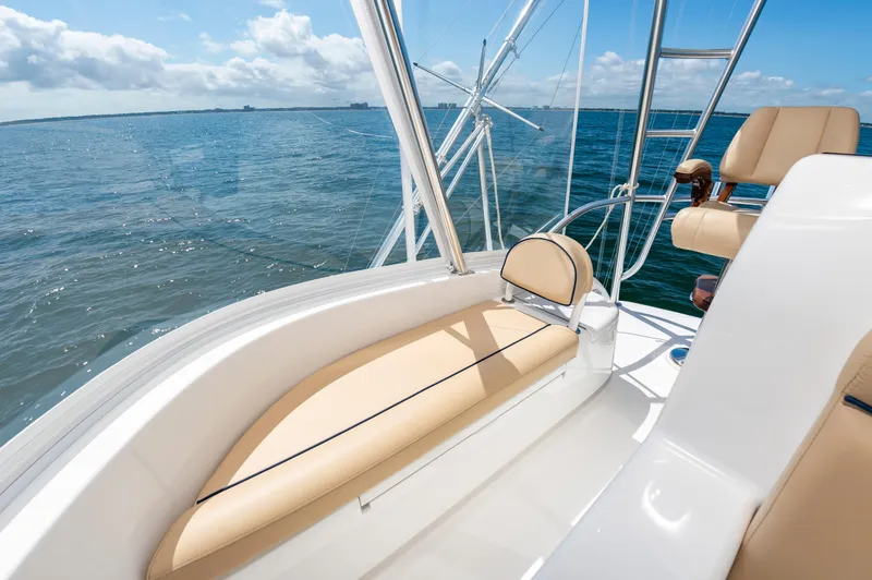 Slide: The Image of Luxurious 2023 Viking 46 yacht interior with beige seating, overlooking serene ocean waters. - 15