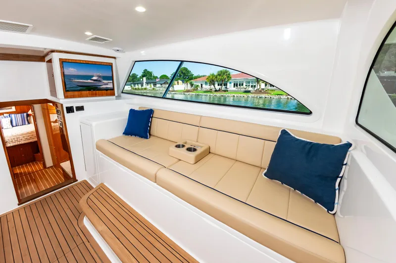 Slide: The Image of Luxurious interior of 2023 Viking 46 yacht with beige seating and scenic window view. - 27
