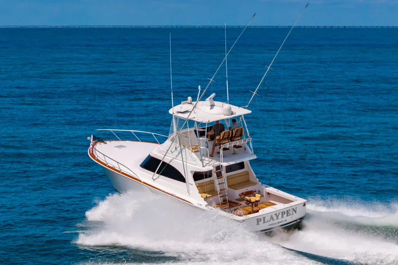 Slide: The Image of 2023 Viking 46 yacht cruising on open ocean waters. - 3