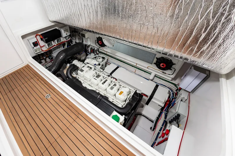Slide: The Image of 2023 Viking 46 engine room with advanced mechanical systems and teak flooring. - 31