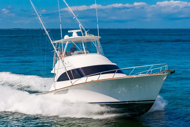 Slide: The Image of 2023 Viking 46 yacht cruising on open blue sea. - 4