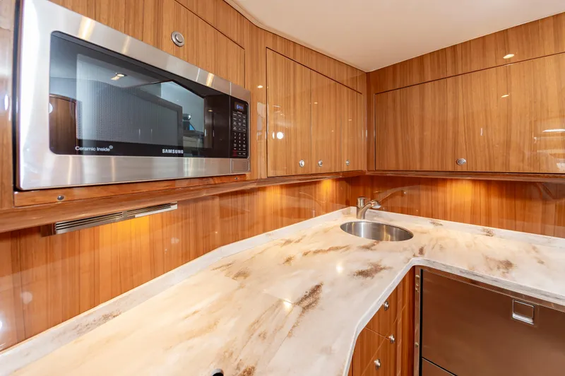 Slide: The Image of Luxurious kitchen in 2023 Viking 46 yacht with wood cabinets and modern appliances. - 45
