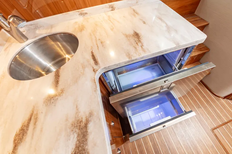 Slide: The Image of Luxury yacht kitchen with marble countertop and stainless steel drawers, Viking 46, 2023 model. - 46