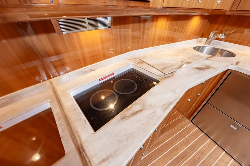 Slide: The Image of Luxurious 2023 Viking 46 yacht kitchen with modern appliances and elegant wood finish. - 47