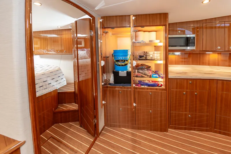 Slide: The Image of Luxurious 2023 Viking 46 yacht interior with wood cabinetry and modern amenities. - 50