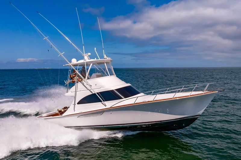 Slide: The Image of 2023 Viking 46 yacht cruising on open sea under blue sky. - 6