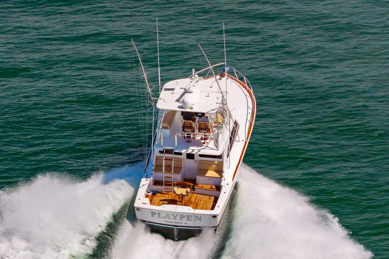 Slide: The Image of 2023 Viking 46 yacht cruising on open water, rear view. - 8