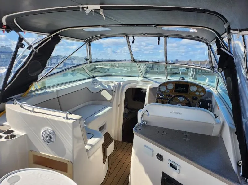Slide: The Image of 2007 Rinker 300 Express Cruiser cockpit with helm, seating, and open cabin view. - 5
