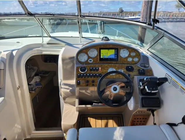 Slide: The Image of 2007 Rinker 300 Express Cruiser cockpit with navigation controls and steering wheel. - 7