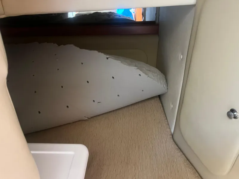 Slide: The Image of 2007 Rinker 300 Express Cruiser cabin interior with damaged upholstery. - 8