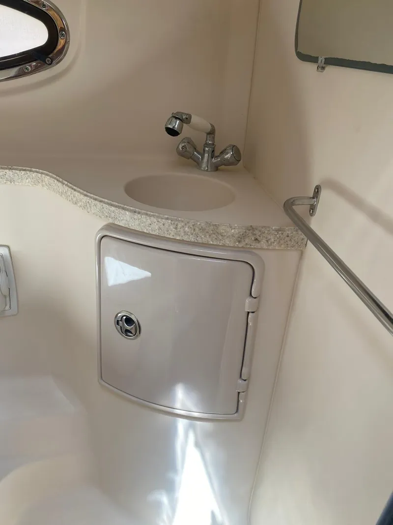 Slide: The Image of 2006 Regal 2860 Window Express boat interior with sink and storage cabinet. - 11