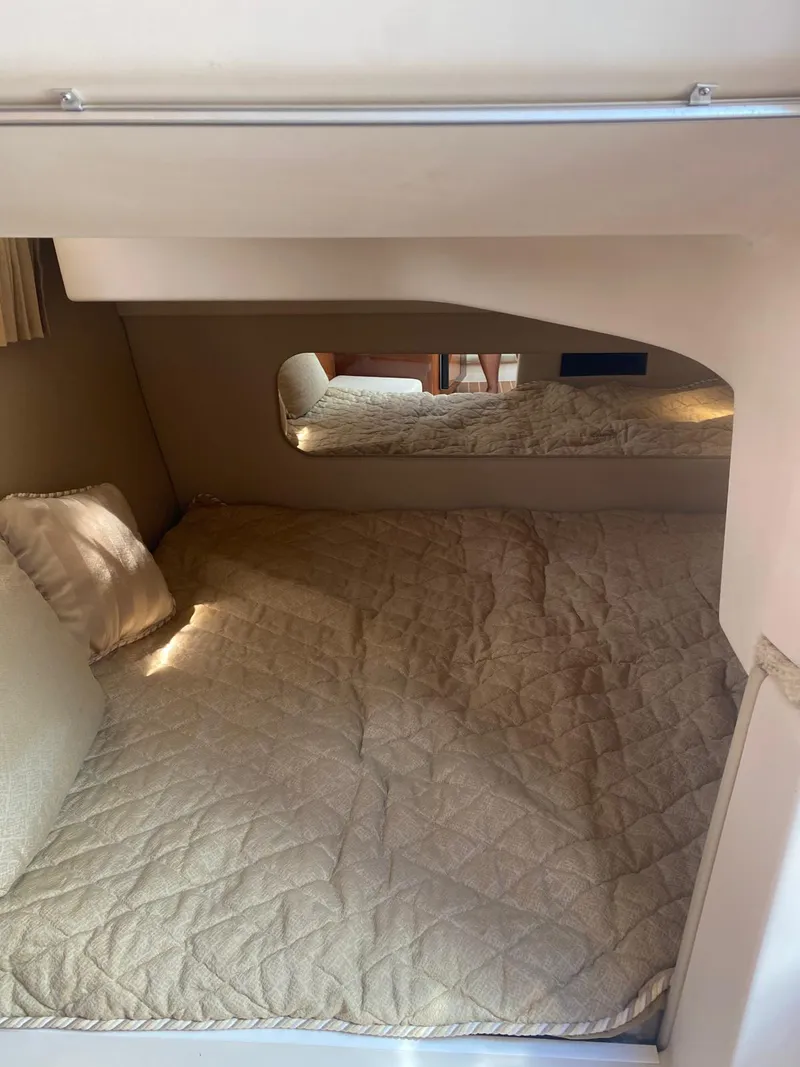 Slide: The Image of Cozy cabin interior of 2006 Regal 2860 Window Express boat with quilted bedding. - 14